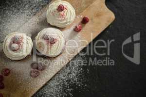 Overhead view of cupcakes on cutting board