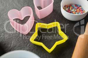 High angle view of pastry cutters with candies in bowl