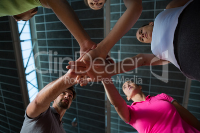 Low angle view of volleyball players stacking hands