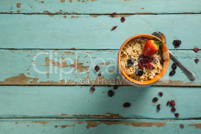Bowls of wheaties cereal with fruits on wooden table