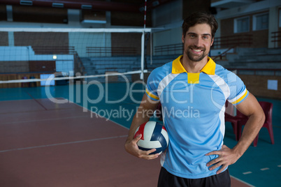 Portrait of smiling sportsperson holding volleyball