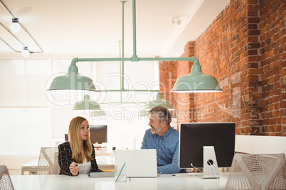 Executive interacting with each other at desk