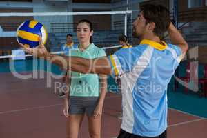 Volleyball player practicing with coach