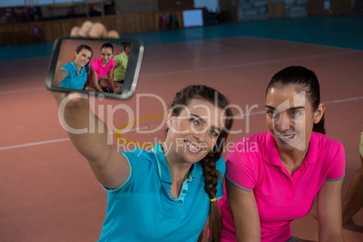 Volleyball player with teammate taking selfie