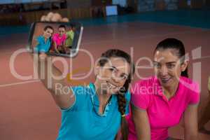 Volleyball player with teammate taking selfie