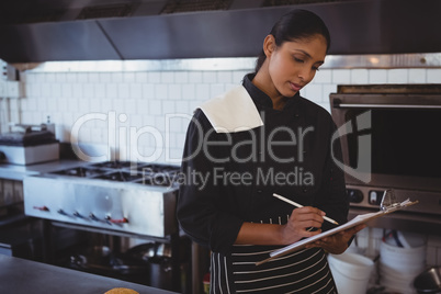 Waitress with clipboard in cafe