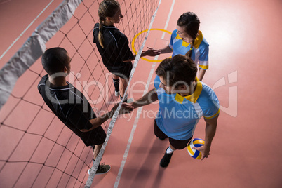 High angle view of volleyball players shaking hands