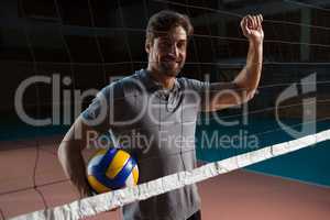 Portrait of male player holding volleyball