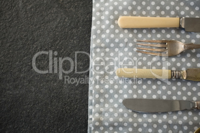 High angle view of cutlery on napkin