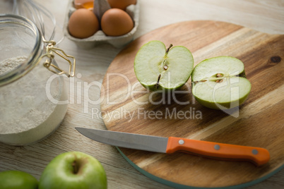 High angle view of granny smith apple halved on cutting board