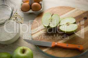 High angle view of granny smith apple halved on cutting board