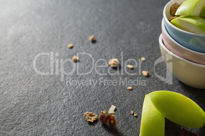 Bowls of breakfast cereals with fruits on black background