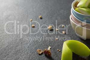 Bowls of breakfast cereals with fruits on black background