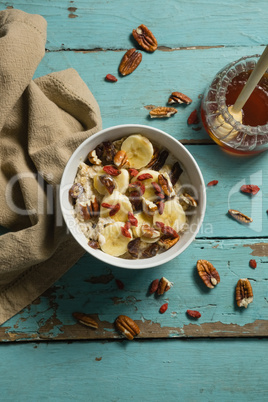 Fruit cereal and honey on a wooden table