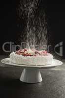 Powdered sugar falling over cake on stand