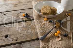 Granola bar and berry fruit on wooden table