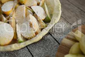 High angle view of powdered sugar on apple slices in baking pan