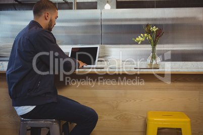 Man using laptop at cafe