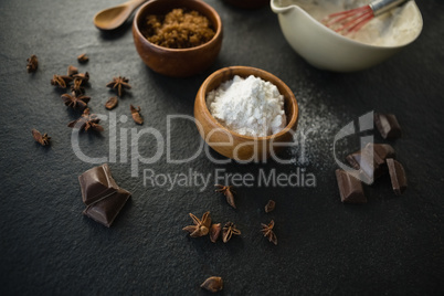 High angle view of flour with spice and chocolate bars