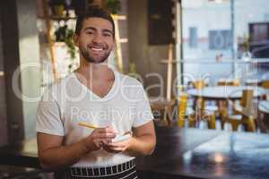 Portrait of smiling waiter taking order