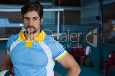 Portrait of confident volleyball player at court