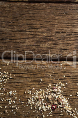 Scattered dry fruits and breakfast cereals on wooden table