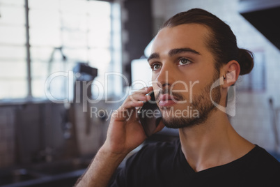 Waiter talking on phone in kitchen