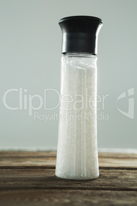 Salt shaker on wooden table