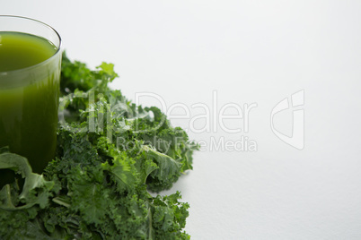 Close up of fresh juice by green kale