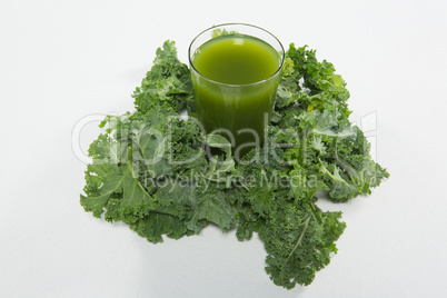 High angle view of juice amidst kale leaves