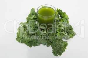 High angle view of juice amidst kale leaves