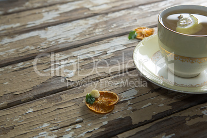 High angle view of lemon and mint leaves in ginger tea on table