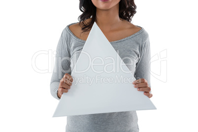 Mid section of woman holding triangle shaped placard