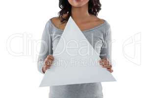 Mid section of woman holding triangle shaped placard
