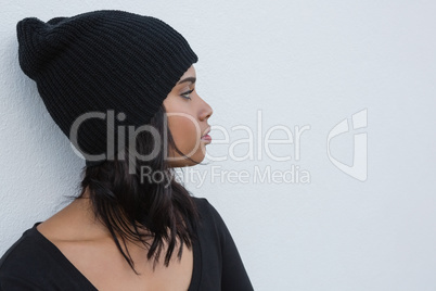 Thoughtful woman against white wall