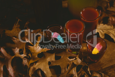 Drinks with autumn leaves on table during Halloween