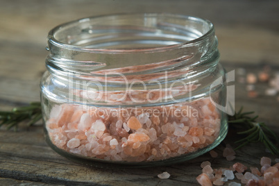 Himalayan salt and rosemary on wooden table