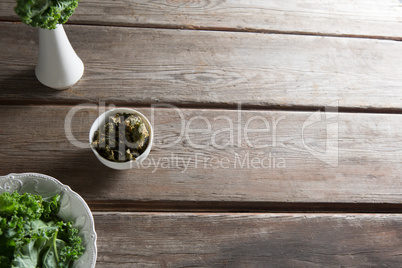 Kale in containers on wooden table