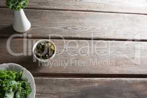 Kale in containers on wooden table