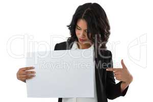 Businesswoman pointing at placard