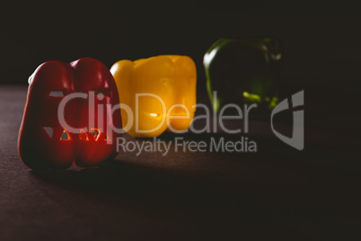 Colorful carved bell peppers on table