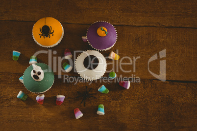 Cup cakes with sweet food on wooden table