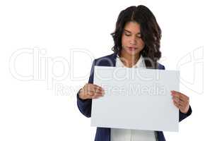Young businesswoman holding blank white placard