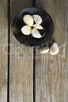 Garlics in plate on wooden table