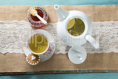 Overhead view of ginger tea with honey on burlap