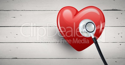 3d heart with stethoscope aginst bright wooden background