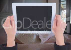 Hand holding tablet at home