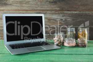 Various type spices in jar and laptop