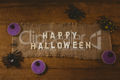 Happy Halloween text on sack with decorations at table
