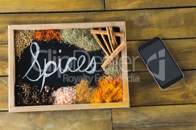 Various type of spices on slate and mobile phone